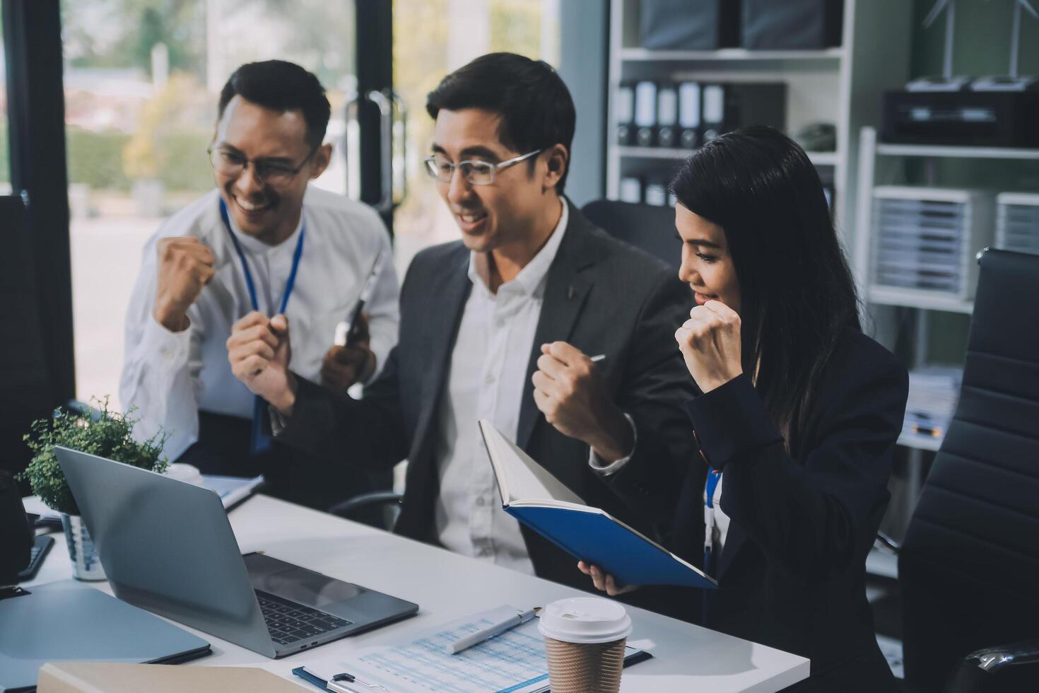 Group of colleagues engaging in a discussion during a business meeting in a conference room. Happy business people, men and women, collaborating and working towards their shared goals. photo