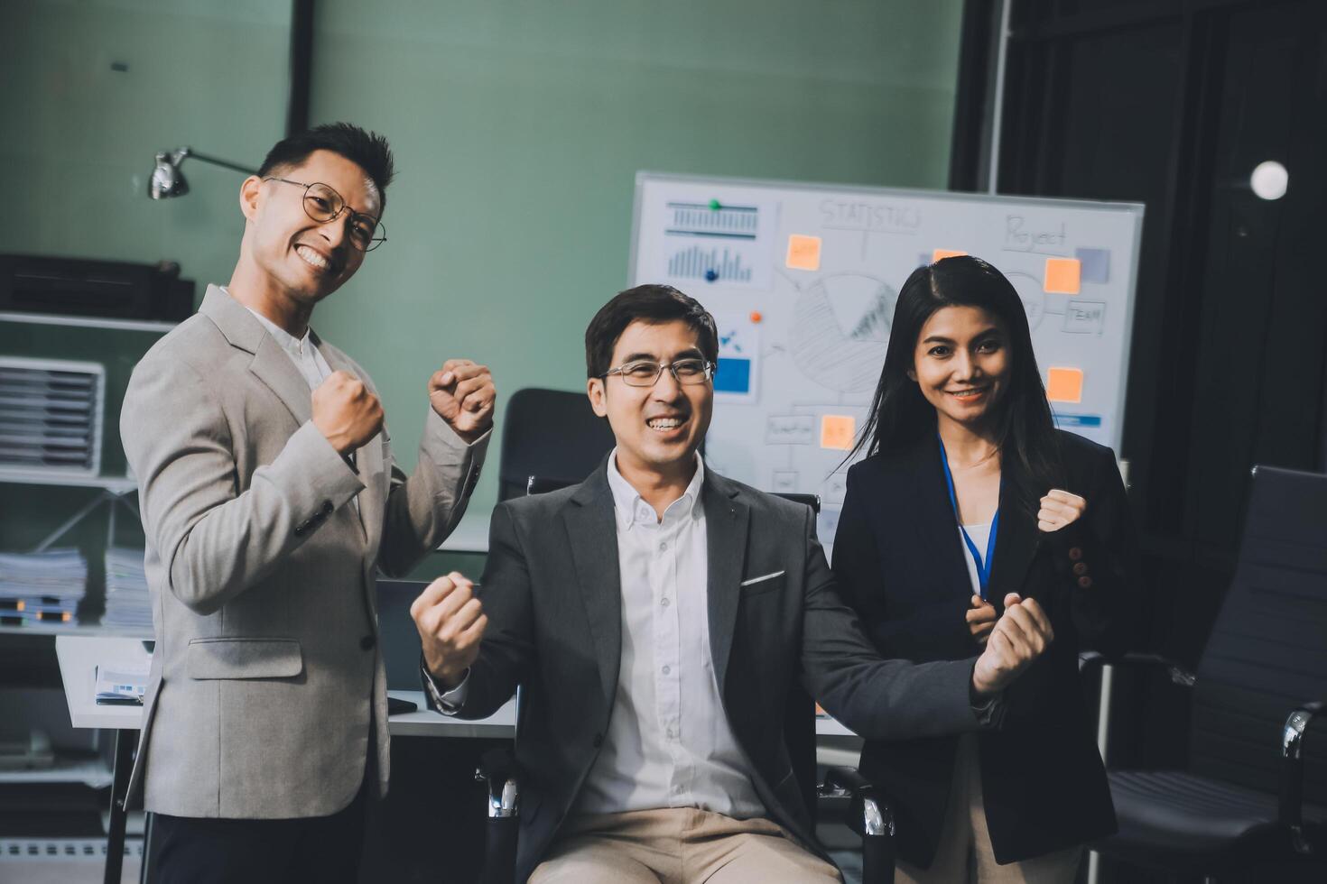 Group of colleagues engaging in a discussion during a business meeting in a conference room. Happy business people, men and women, collaborating and working towards their shared goals. photo