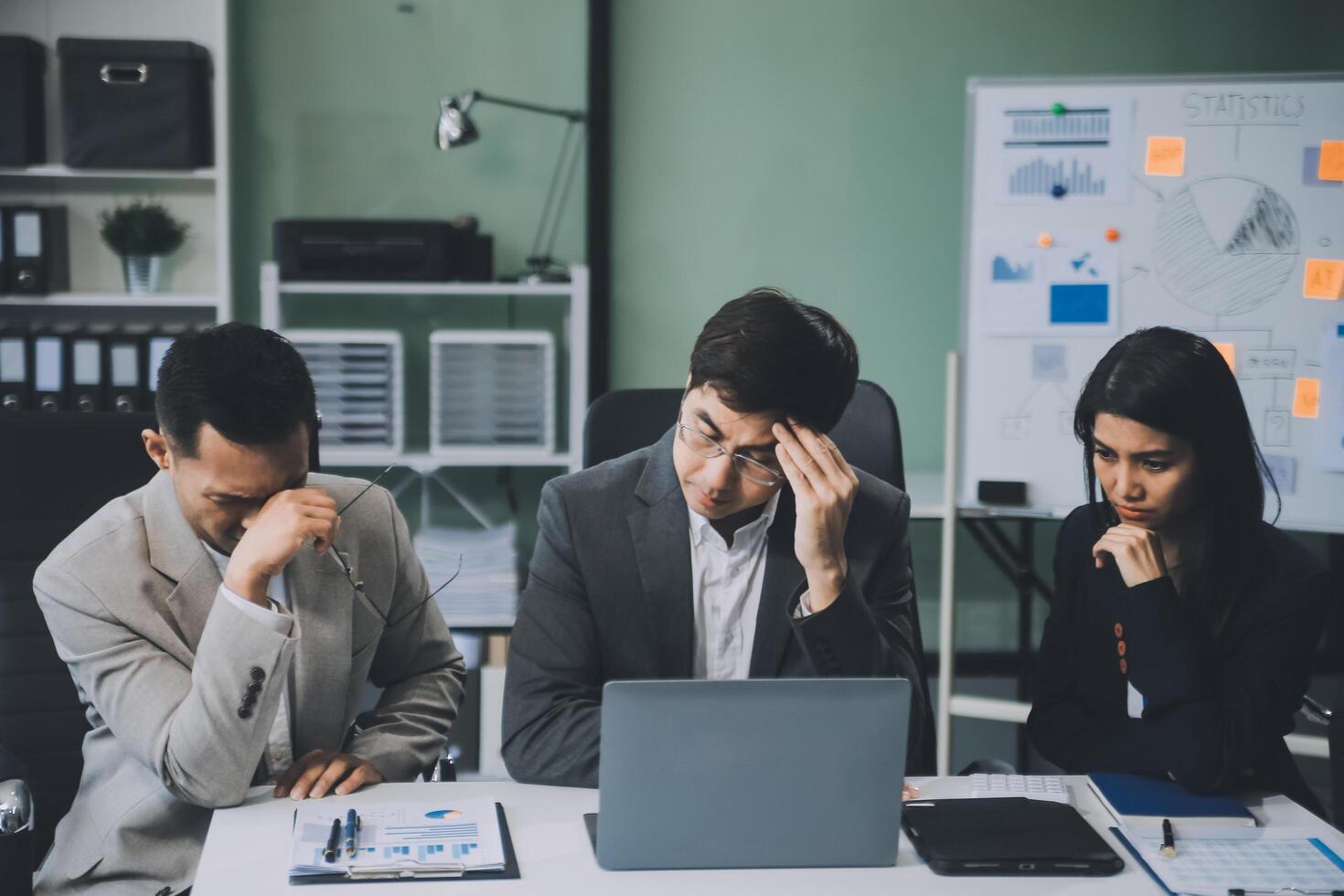 Group of colleagues engaging in a discussion during a business meeting in a conference room. Happy business people, men and women, collaborating and working towards their shared goals. photo