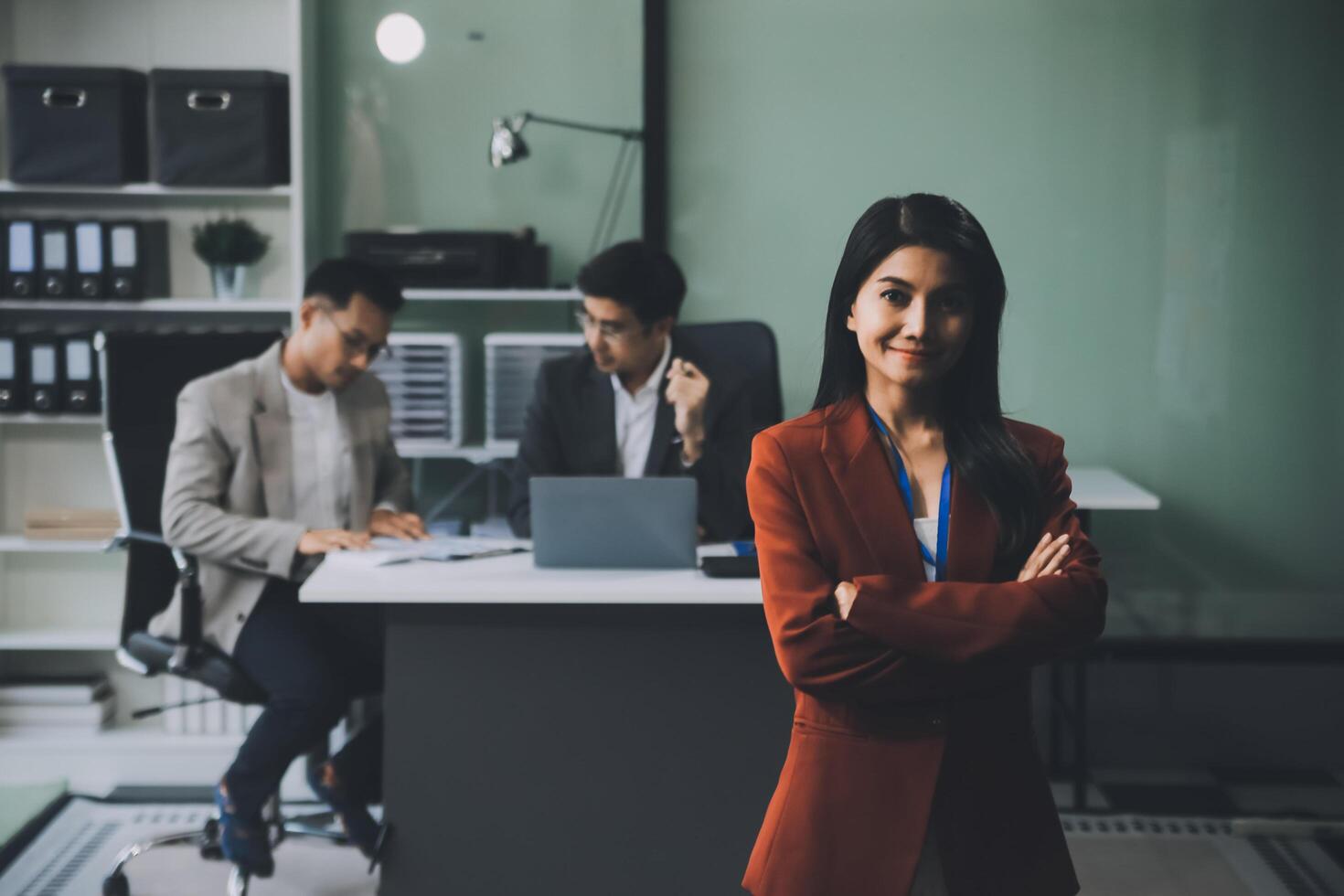 Group of colleagues engaging in a discussion during a business meeting in a conference room. Happy business people, men and women, collaborating and working towards their shared goals. photo