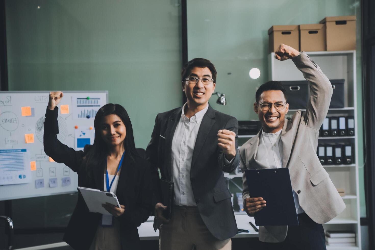 Group of colleagues engaging in a discussion during a business meeting in a conference room. Happy business people, men and women, collaborating and working towards their shared goals. photo