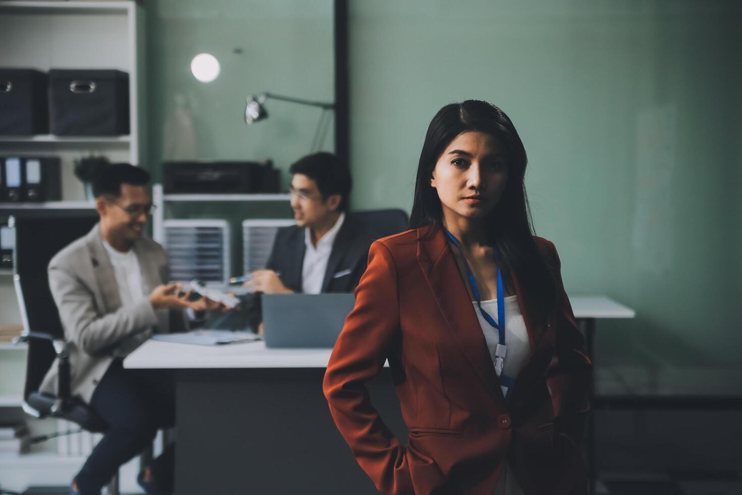 Group of colleagues engaging in a discussion during a business meeting in a conference room. Happy business people, men and women, collaborating and working towards their shared goals. photo