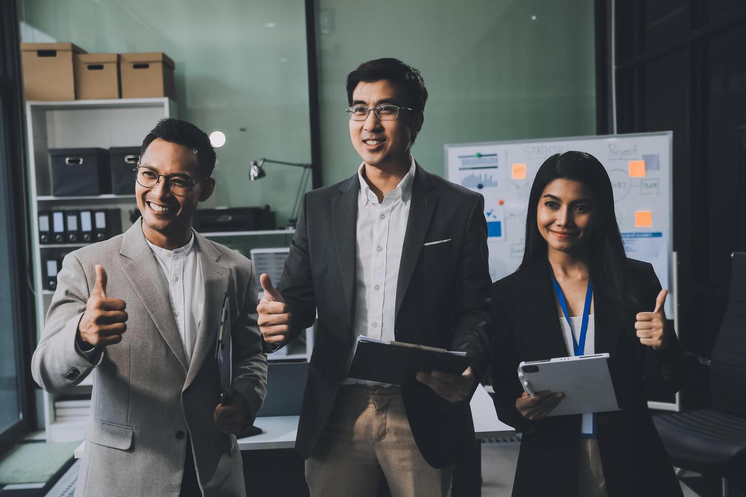 Group of colleagues engaging in a discussion during a business meeting in a conference room. Happy business people, men and women, collaborating and working towards their shared goals. photo