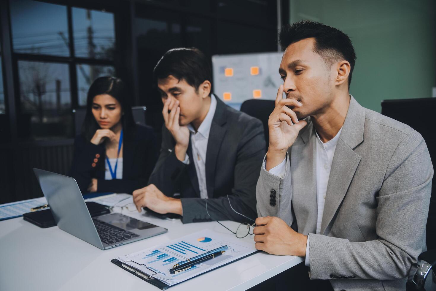 Group of colleagues engaging in a discussion during a business meeting in a conference room. Happy business people, men and women, collaborating and working towards their shared goals. photo