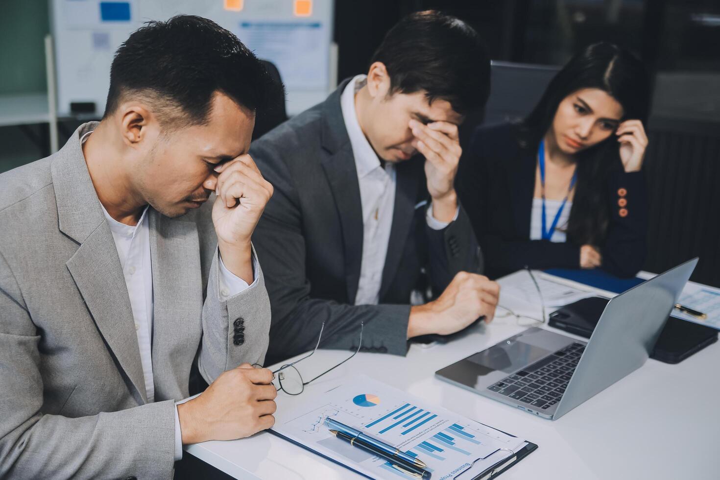 Group of colleagues engaging in a discussion during a business meeting in a conference room. Happy business people, men and women, collaborating and working towards their shared goals. photo