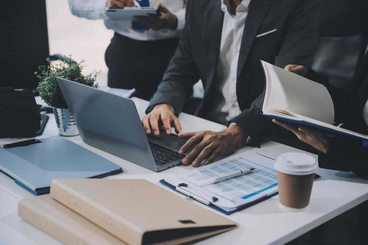 Group of colleagues engaging in a discussion during a business meeting in a conference room. Happy business people, men and women, collaborating and working towards their shared goals. photo