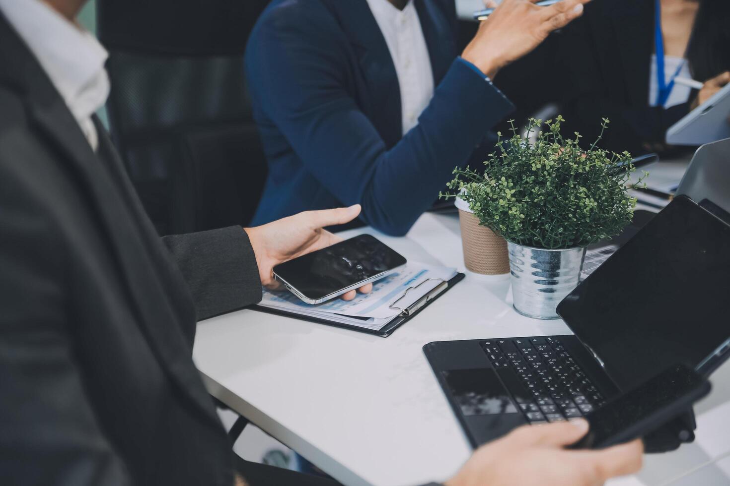 Group of colleagues engaging in a discussion during a business meeting in a conference room. Happy business people, men and women, collaborating and working towards their shared goals. photo
