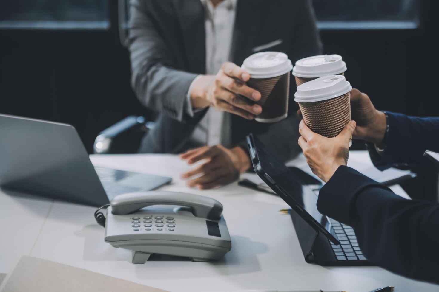 Group of colleagues engaging in a discussion during a business meeting in a conference room. Happy business people, men and women, collaborating and working towards their shared goals. photo