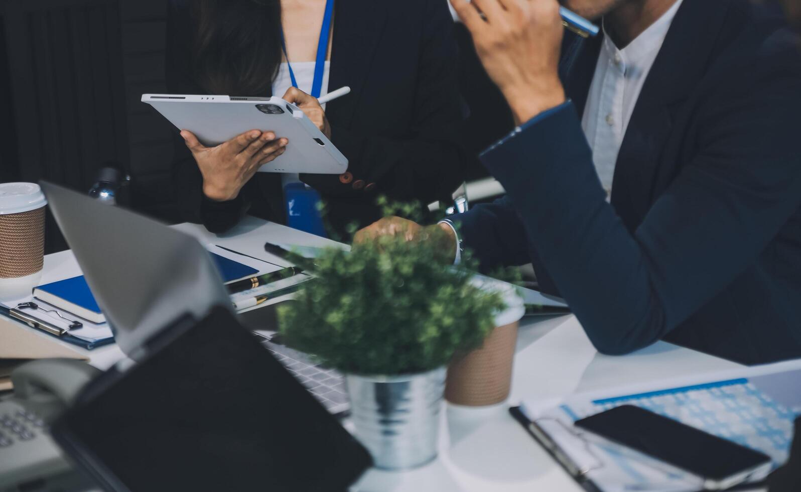 Group of colleagues engaging in a discussion during a business meeting in a conference room. Happy business people, men and women, collaborating and working towards their shared goals. photo