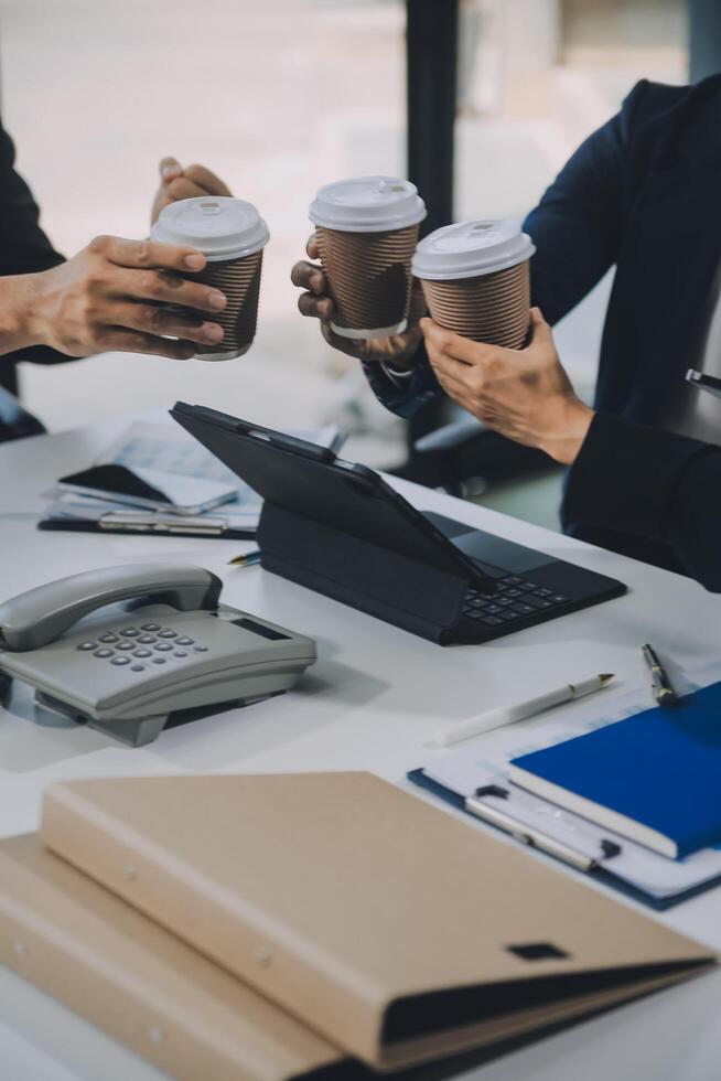 Group of colleagues engaging in a discussion during a business meeting in a conference room. Happy business people, men and women, collaborating and working towards their shared goals. photo