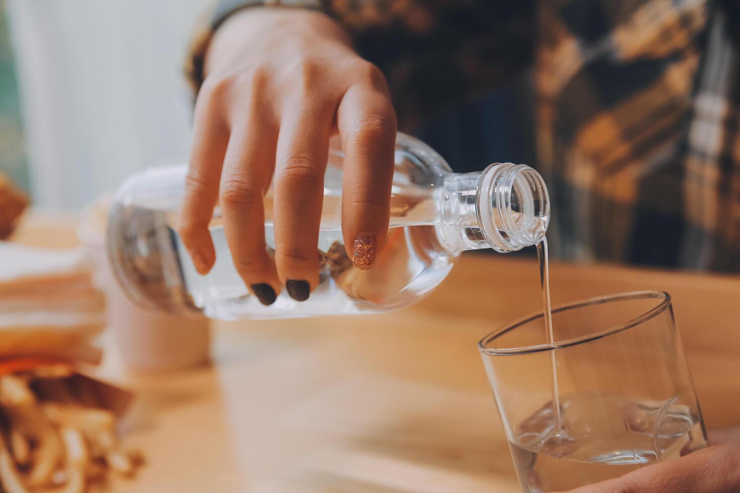 healthy beautiful young woman holding glass of water photo