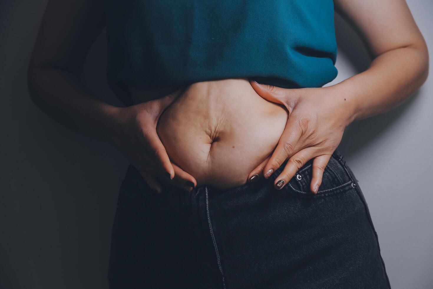 fat woman, fat belly, chubby, obese woman hand holding excessive belly fat with measure tape, woman diet lifestyle concept photo