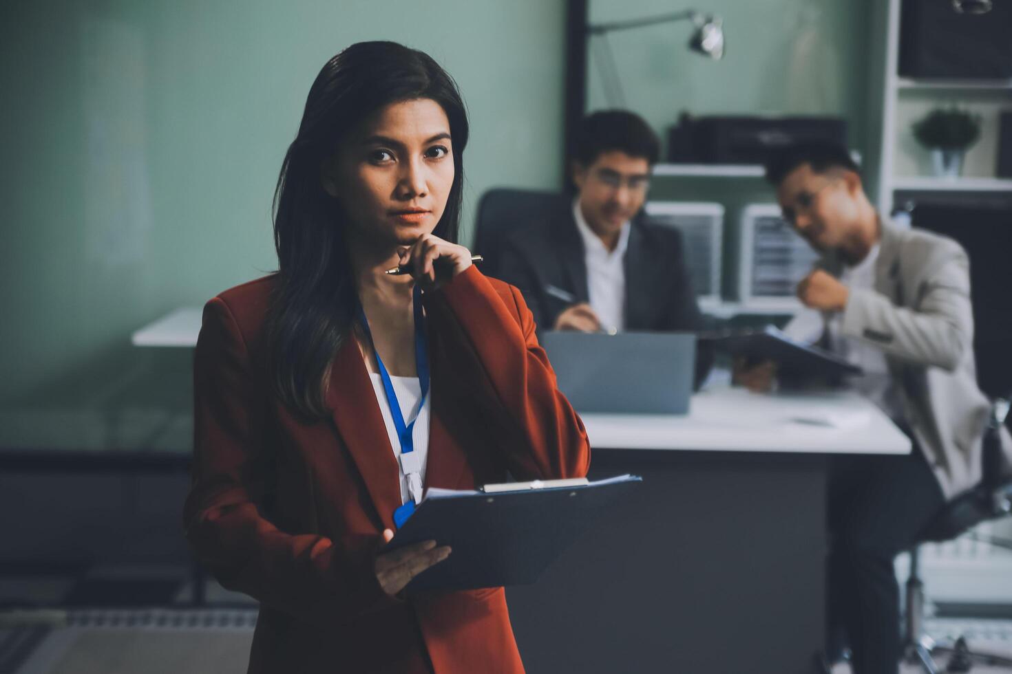 Group of colleagues engaging in a discussion during a business meeting in a conference room. Happy business people, men and women, collaborating and working towards their shared goals. photo