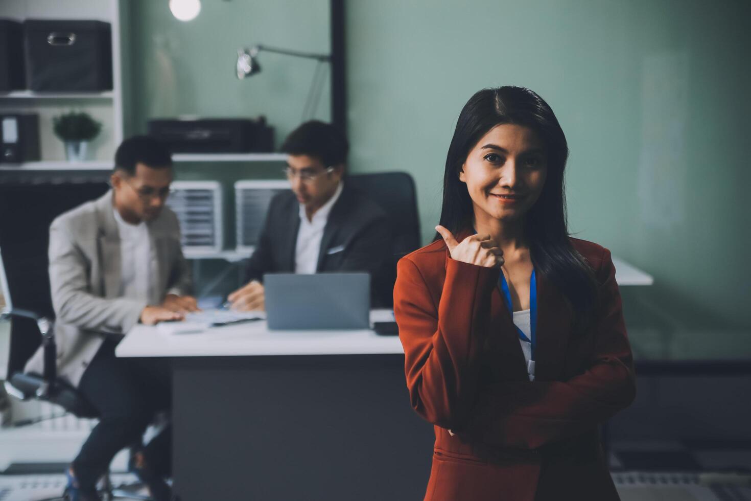 Group of colleagues engaging in a discussion during a business meeting in a conference room. Happy business people, men and women, collaborating and working towards their shared goals. photo
