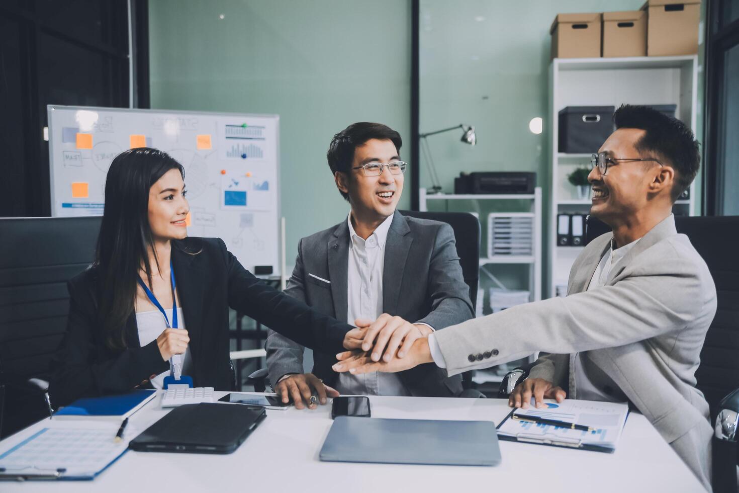 Group of colleagues engaging in a discussion during a business meeting in a conference room. Happy business people, men and women, collaborating and working towards their shared goals. photo