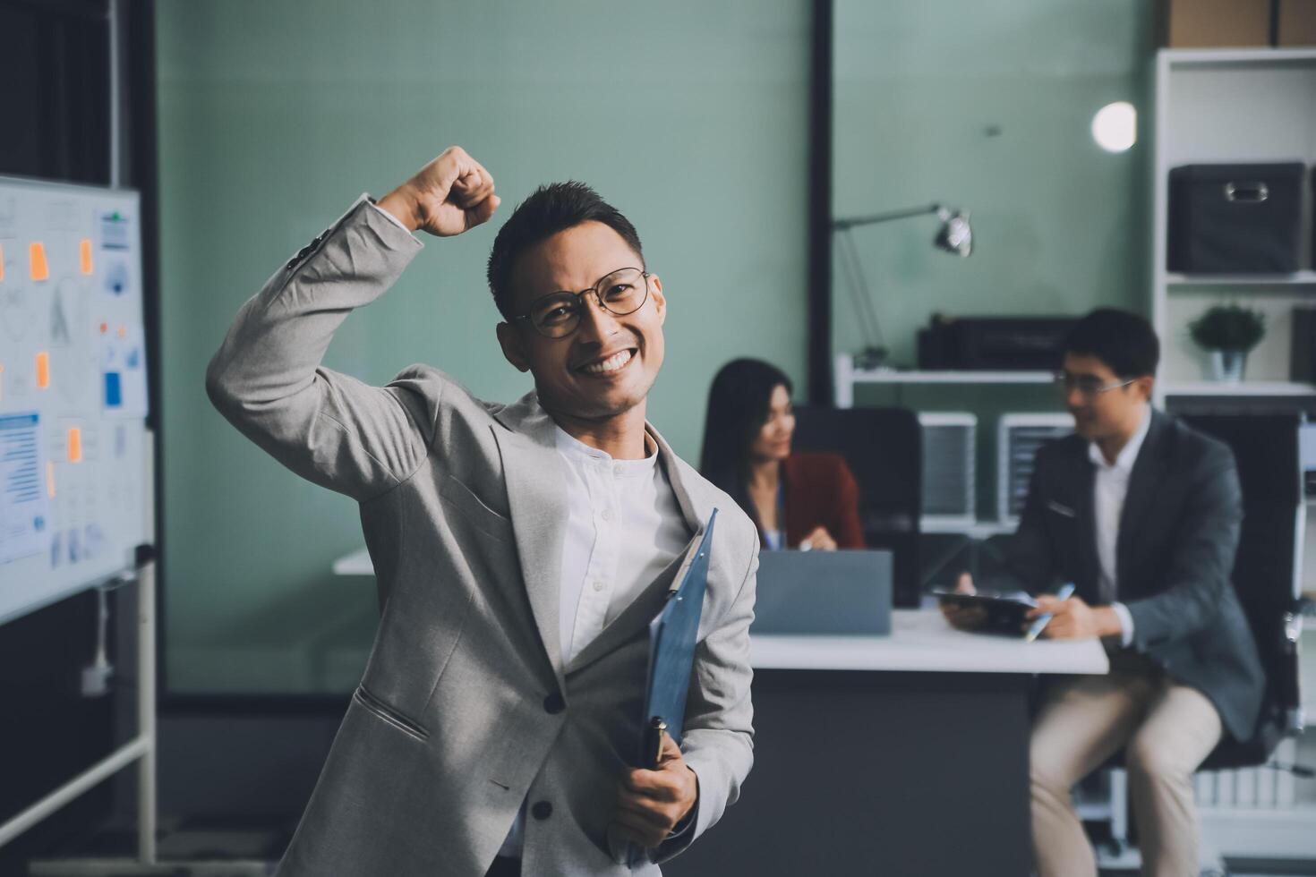 Group of colleagues engaging in a discussion during a business meeting in a conference room. Happy business people, men and women, collaborating and working towards their shared goals. photo