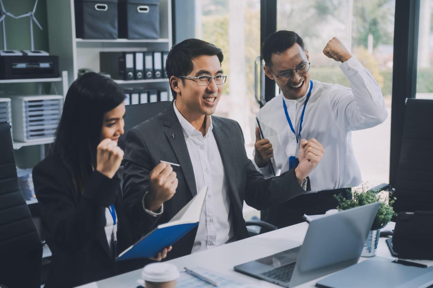 Group of colleagues engaging in a discussion during a business meeting in a conference room. Happy business people, men and women, collaborating and working towards their shared goals. photo