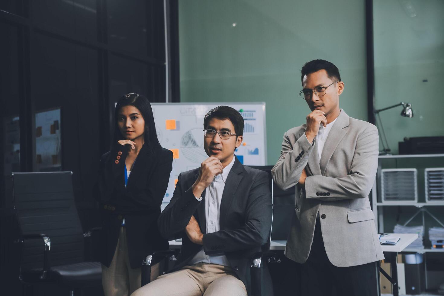 Group of colleagues engaging in a discussion during a business meeting in a conference room. Happy business people, men and women, collaborating and working towards their shared goals. photo