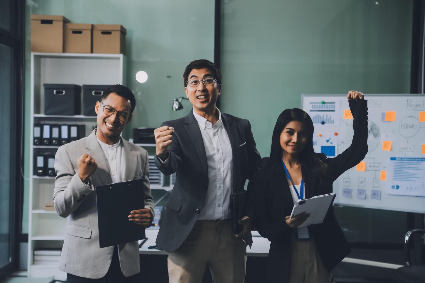 Group of colleagues engaging in a discussion during a business meeting in a conference room. Happy business people, men and women, collaborating and working towards their shared goals. photo