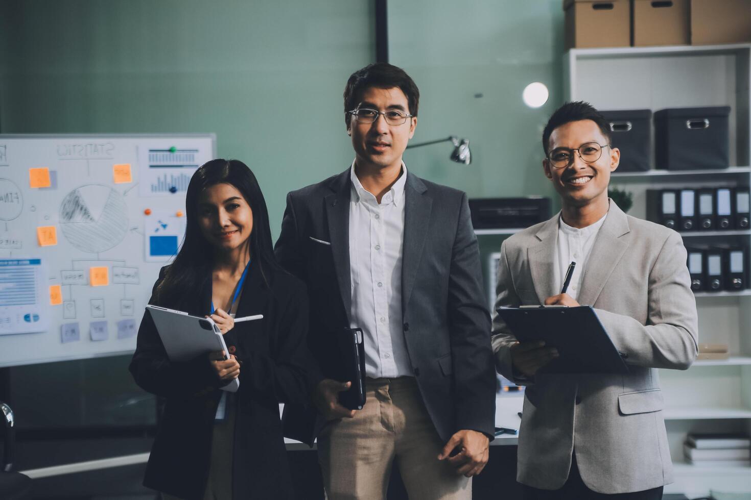 Group of colleagues engaging in a discussion during a business meeting in a conference room. Happy business people, men and women, collaborating and working towards their shared goals. photo