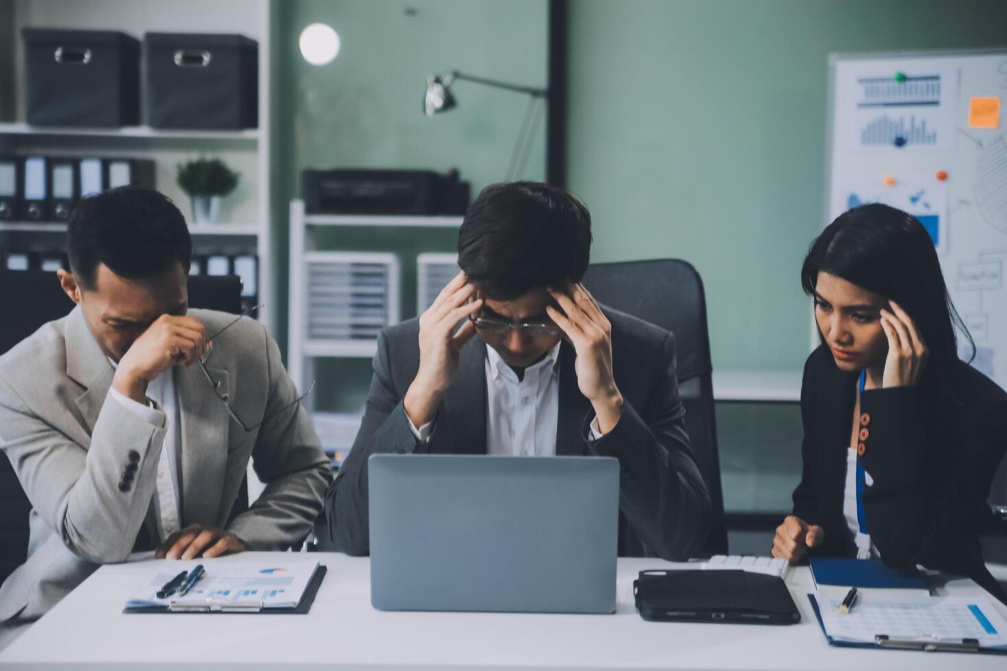 Group of colleagues engaging in a discussion during a business meeting in a conference room. Happy business people, men and women, collaborating and working towards their shared goals. photo