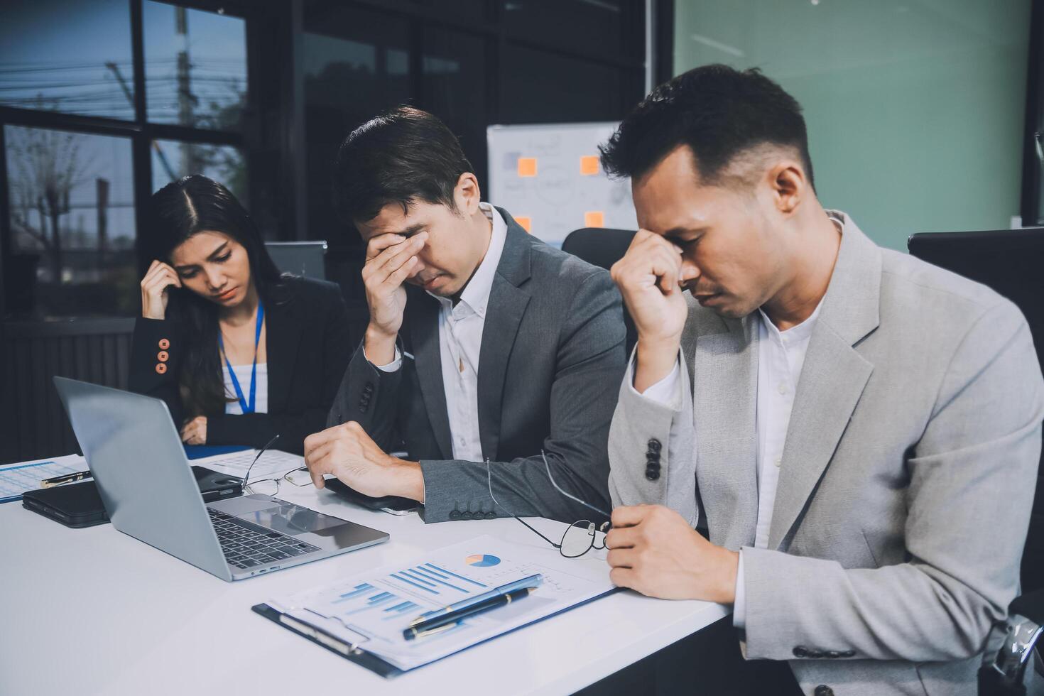Group of colleagues engaging in a discussion during a business meeting in a conference room. Happy business people, men and women, collaborating and working towards their shared goals. photo