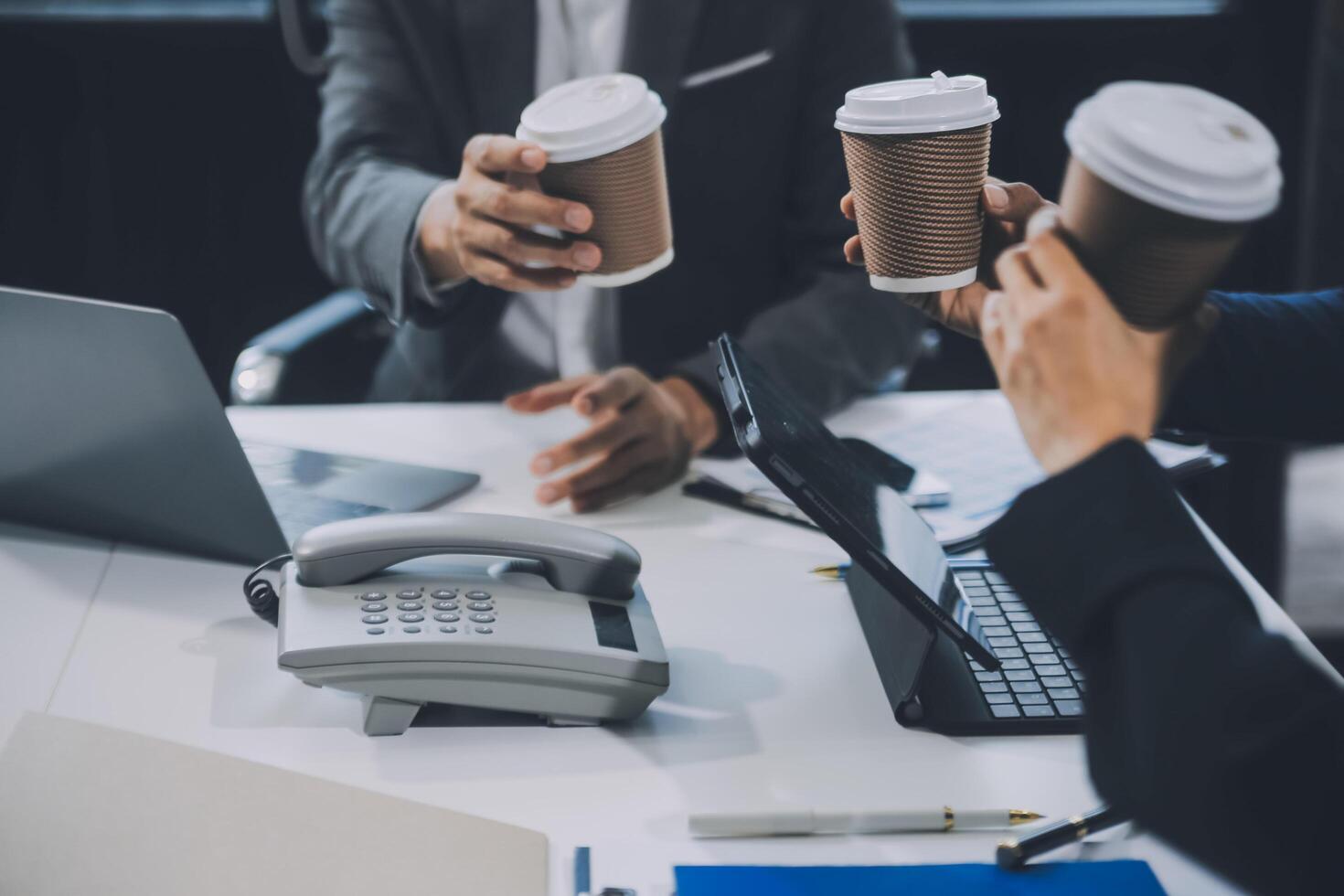 Group of colleagues engaging in a discussion during a business meeting in a conference room. Happy business people, men and women, collaborating and working towards their shared goals. photo