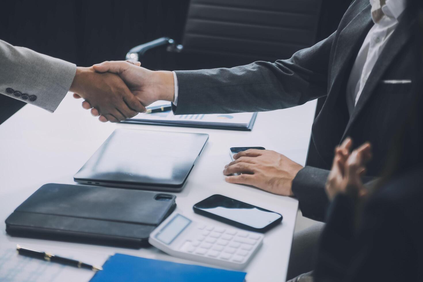 Group of colleagues engaging in a discussion during a business meeting in a conference room. Happy business people, men and women, collaborating and working towards their shared goals. photo