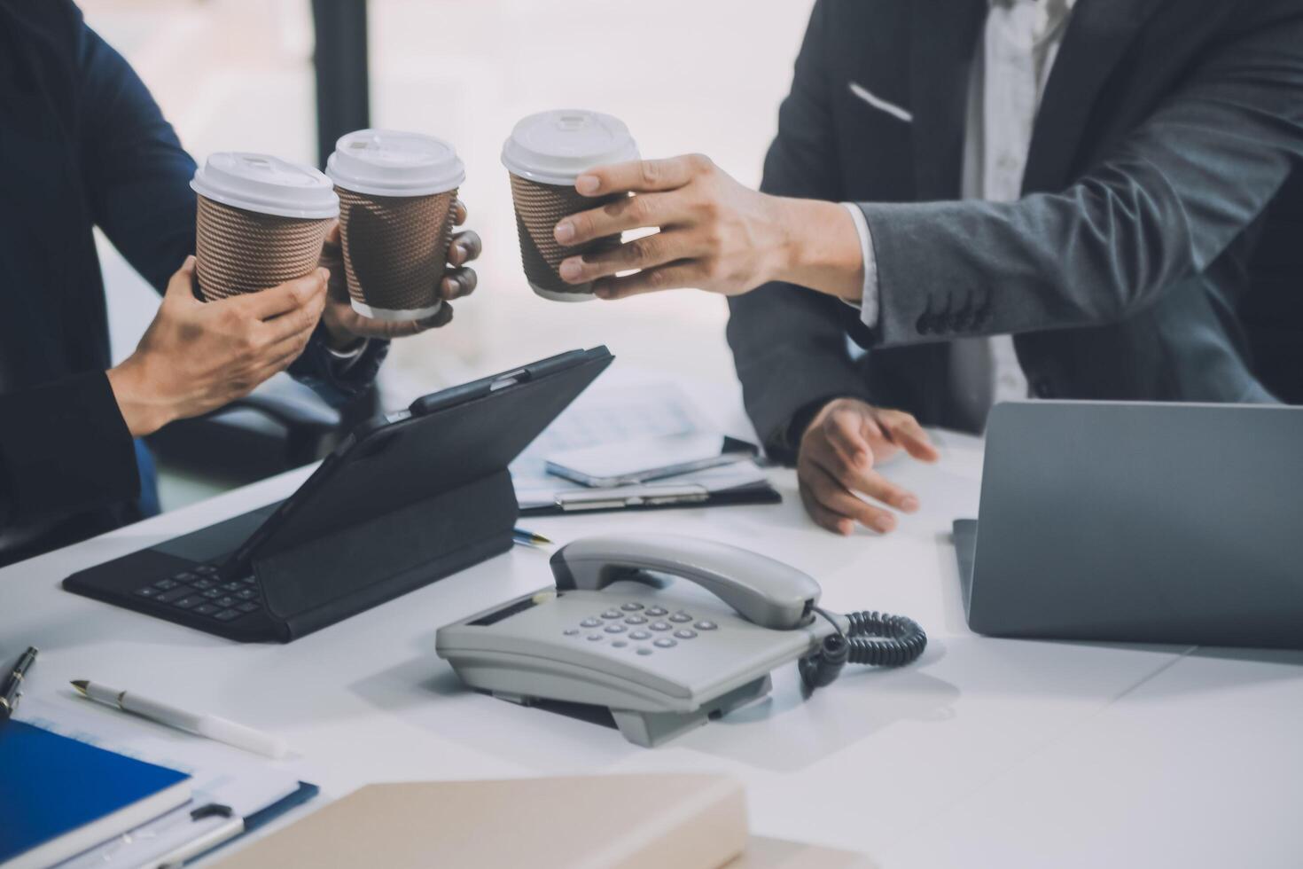 Group of colleagues engaging in a discussion during a business meeting in a conference room. Happy business people, men and women, collaborating and working towards their shared goals. photo