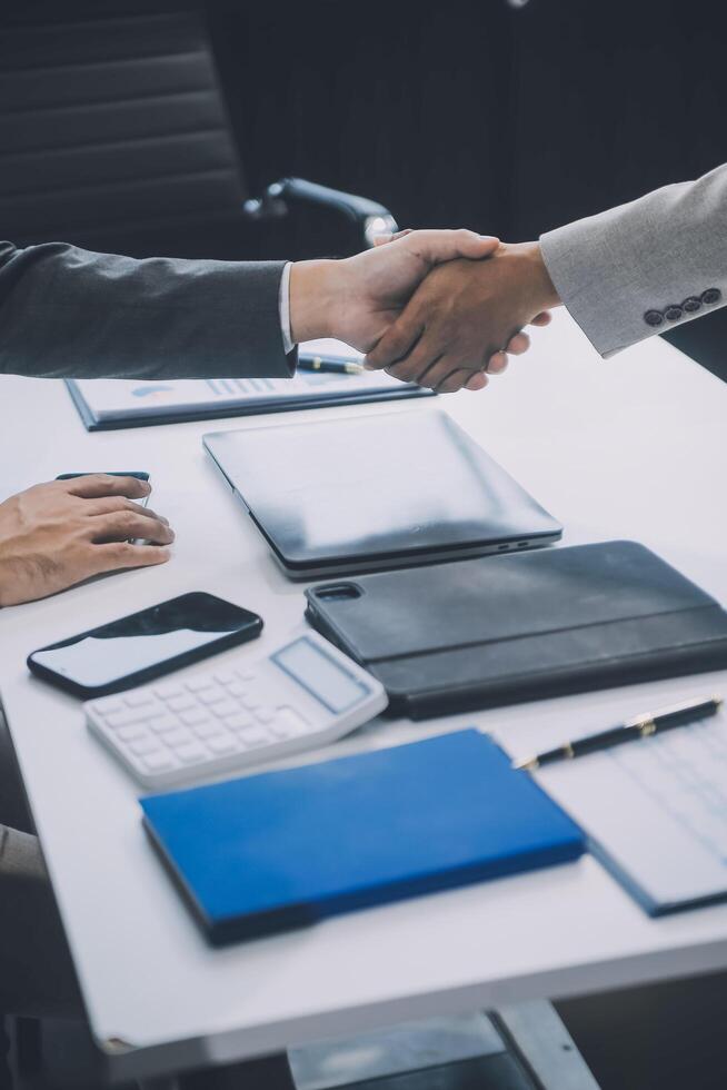 Group of colleagues engaging in a discussion during a business meeting in a conference room. Happy business people, men and women, collaborating and working towards their shared goals. photo