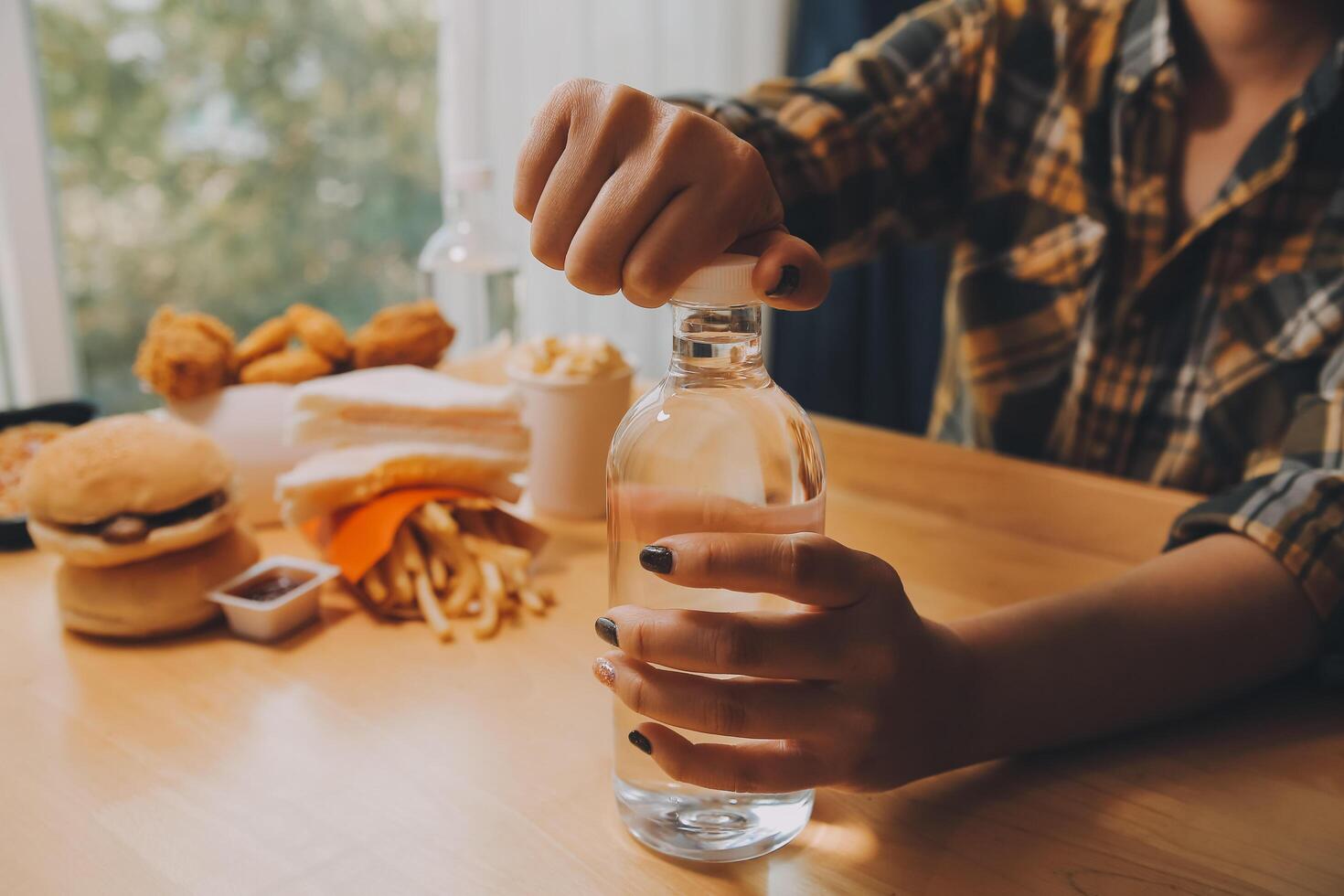 healthy beautiful young woman holding glass of water photo