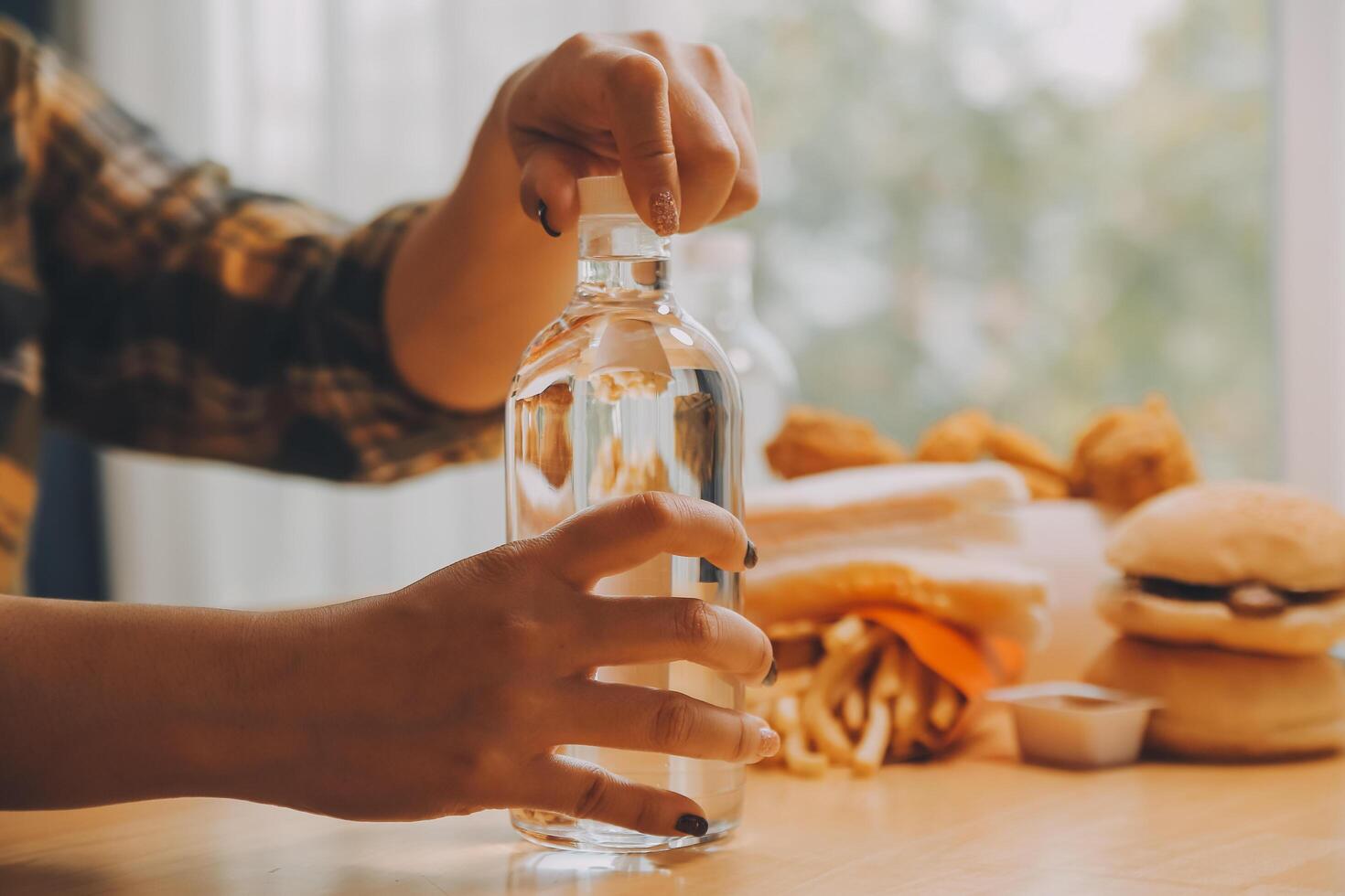 healthy beautiful young woman holding glass of water photo