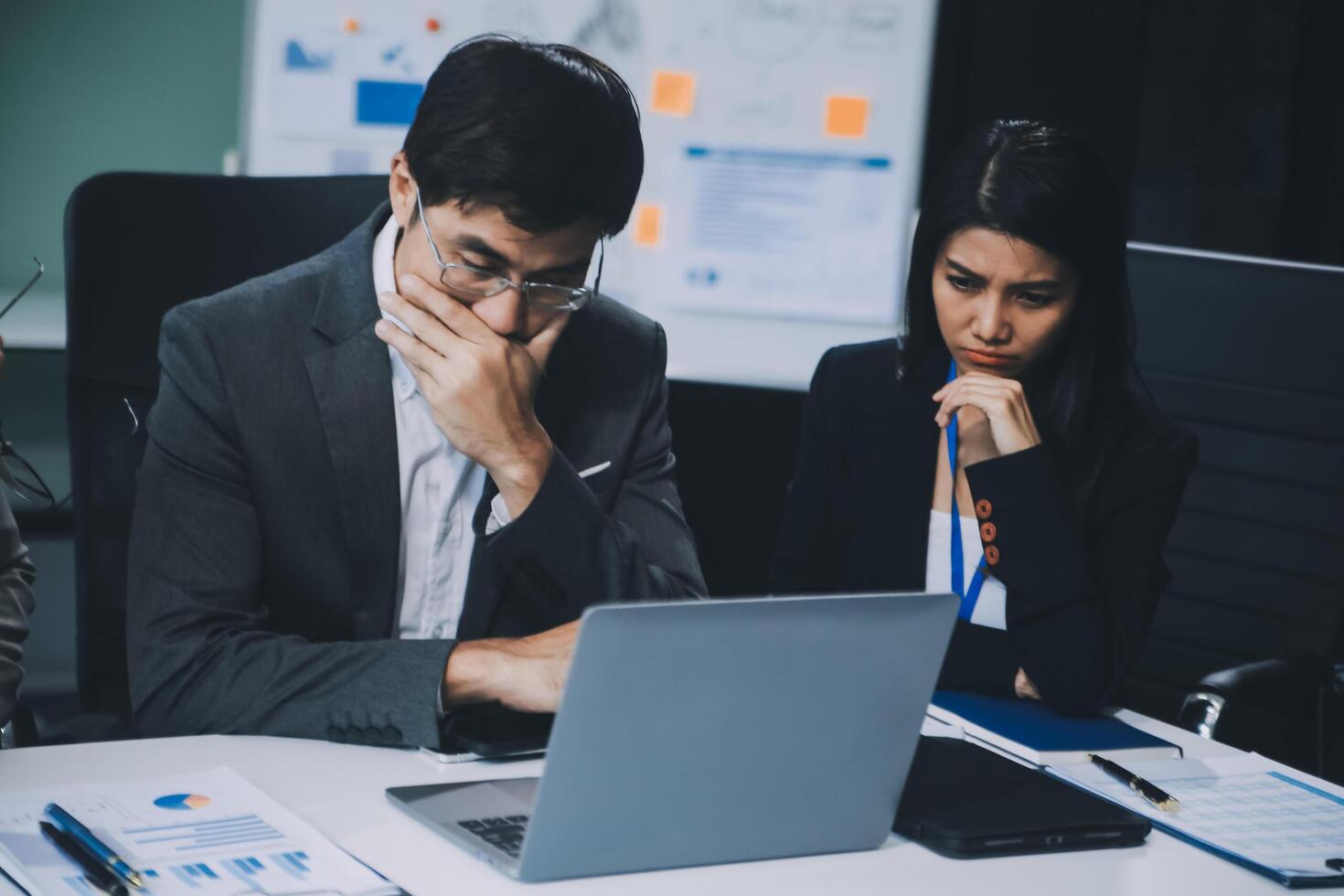 Group of colleagues engaging in a discussion during a business meeting in a conference room. Happy business people, men and women, collaborating and working towards their shared goals. photo