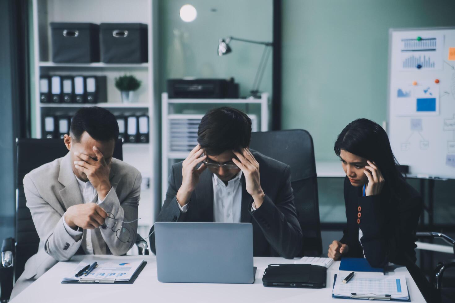 Group of colleagues engaging in a discussion during a business meeting in a conference room. Happy business people, men and women, collaborating and working towards their shared goals. photo