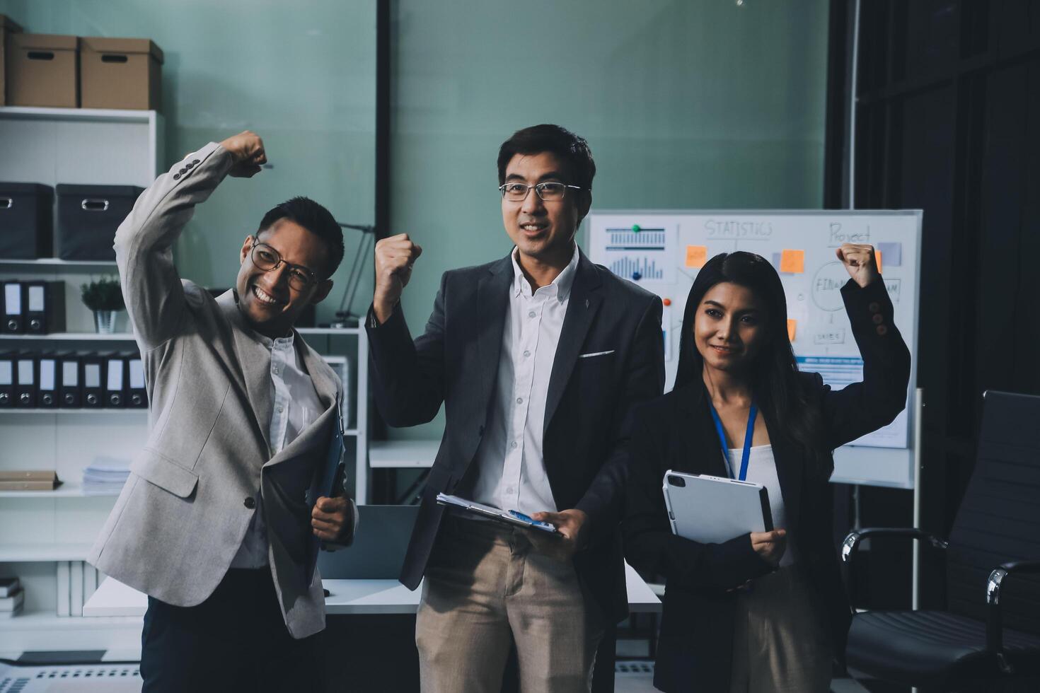 Group of colleagues engaging in a discussion during a business meeting in a conference room. Happy business people, men and women, collaborating and working towards their shared goals. photo