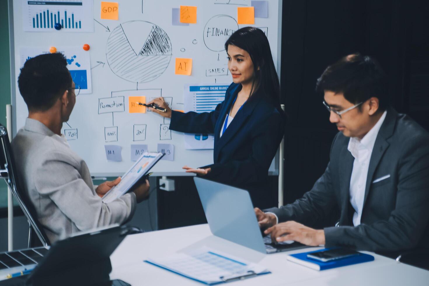 Group of confident business people point to graphs and charts to analyze market data, balance sheet, account, net profit to plan new sales strategies to increase production capacity. photo