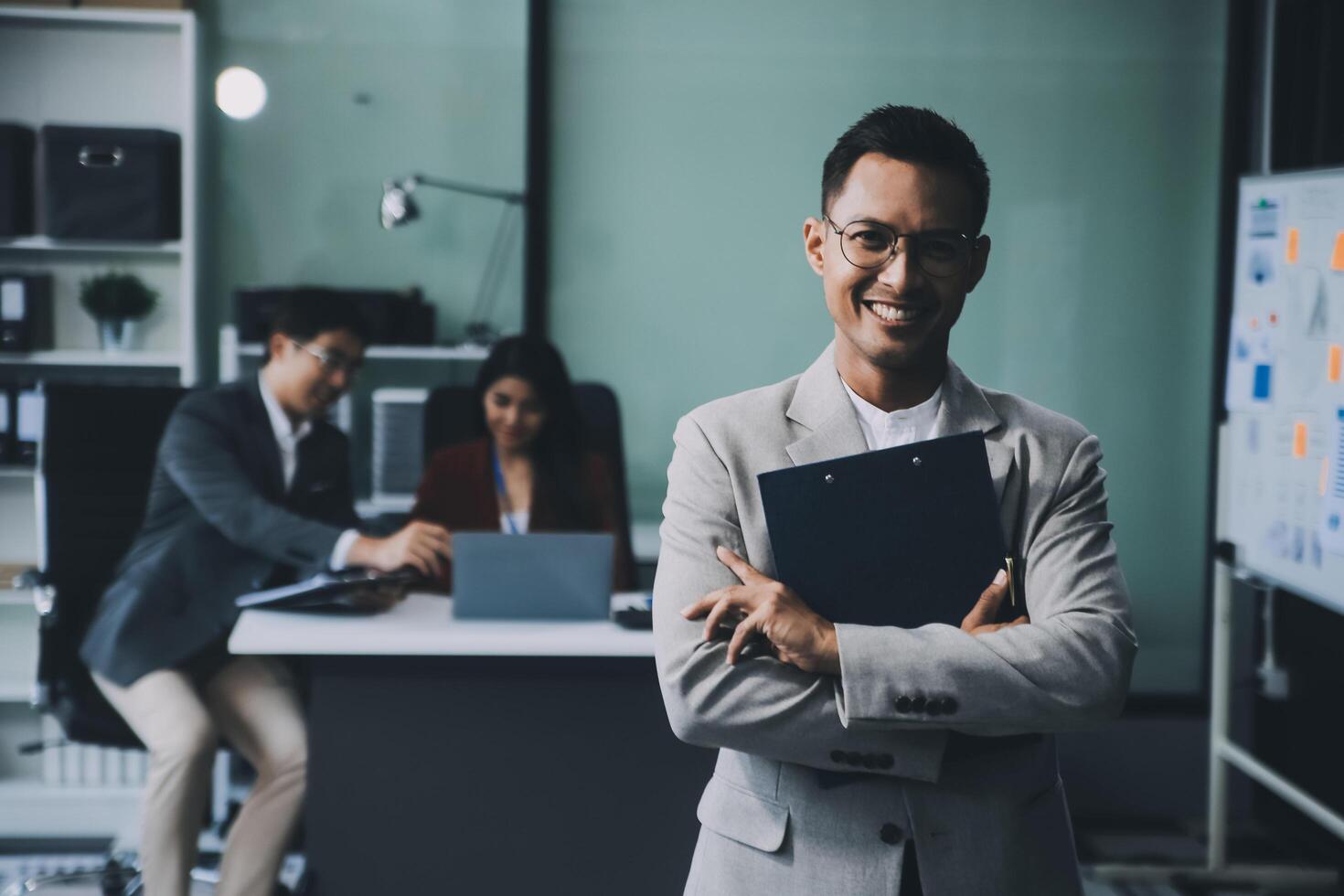 Group of colleagues engaging in a discussion during a business meeting in a conference room. Happy business people, men and women, collaborating and working towards their shared goals. photo