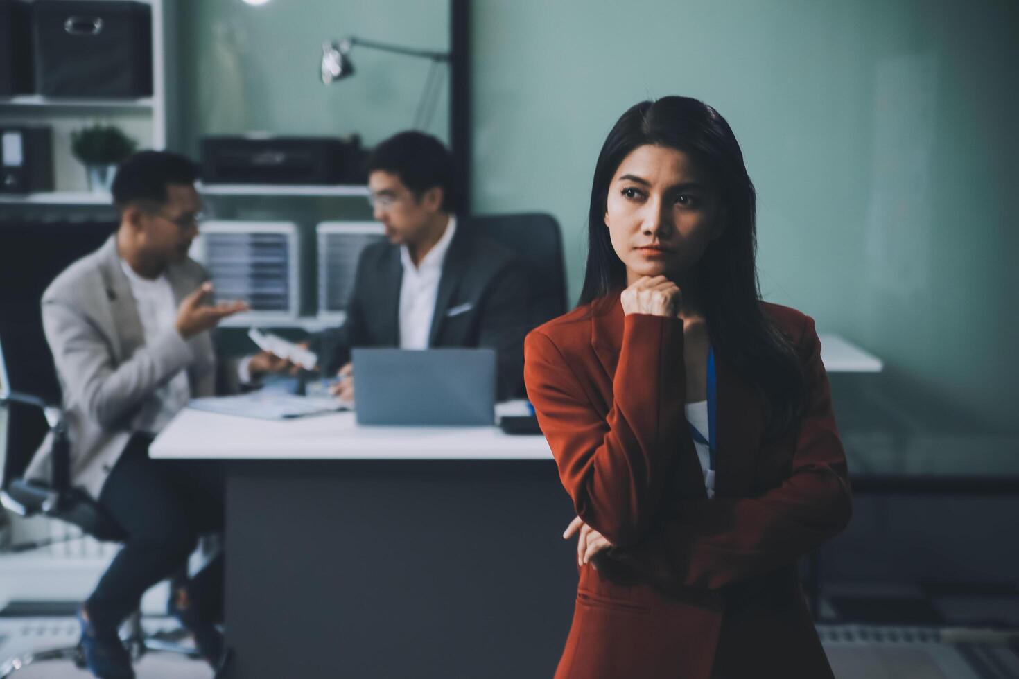 Group of colleagues engaging in a discussion during a business meeting in a conference room. Happy business people, men and women, collaborating and working towards their shared goals. photo