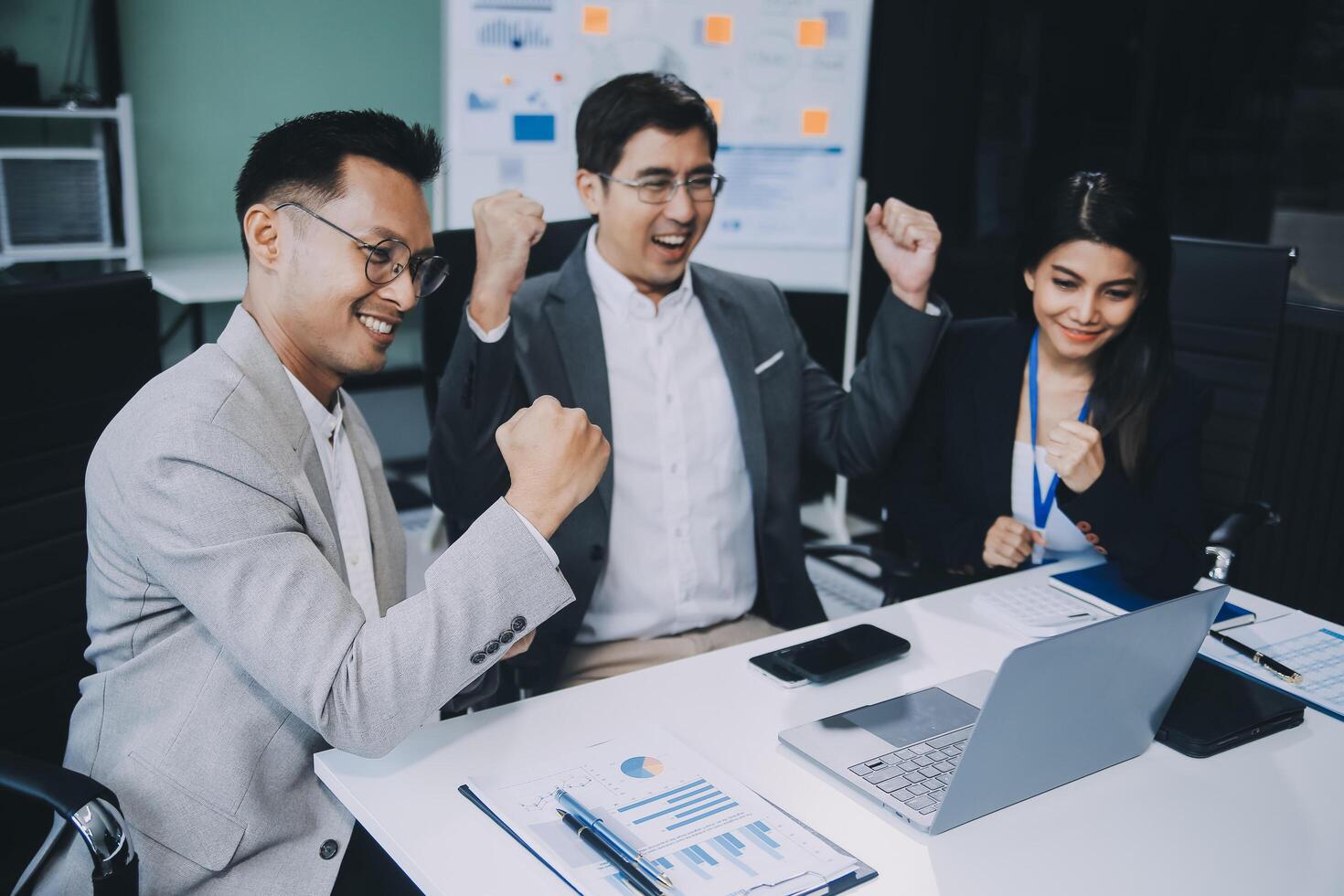 Group of colleagues engaging in a discussion during a business meeting in a conference room. Happy business people, men and women, collaborating and working towards their shared goals. photo