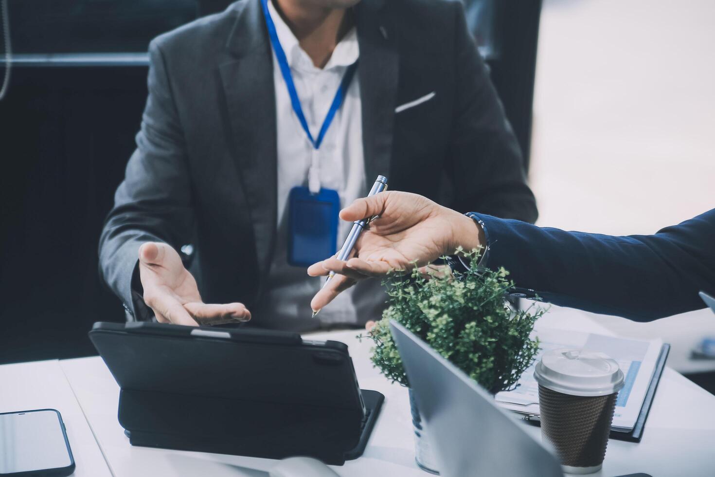 Group of colleagues engaging in a discussion during a business meeting in a conference room. Happy business people, men and women, collaborating and working towards their shared goals. photo