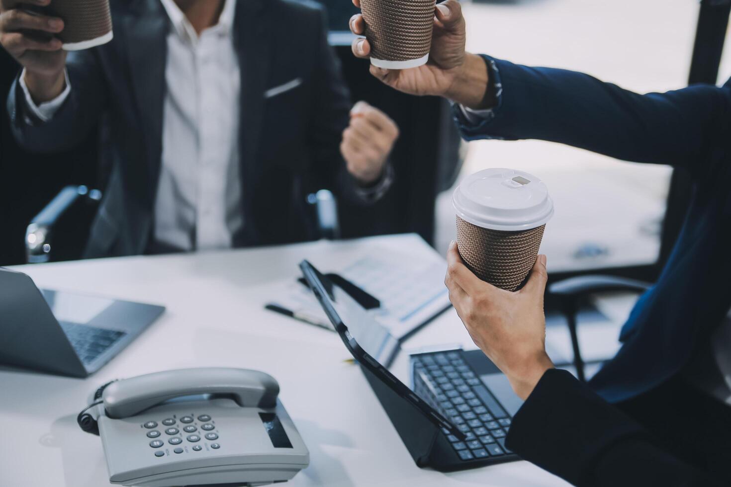 Group of colleagues engaging in a discussion during a business meeting in a conference room. Happy business people, men and women, collaborating and working towards their shared goals. photo