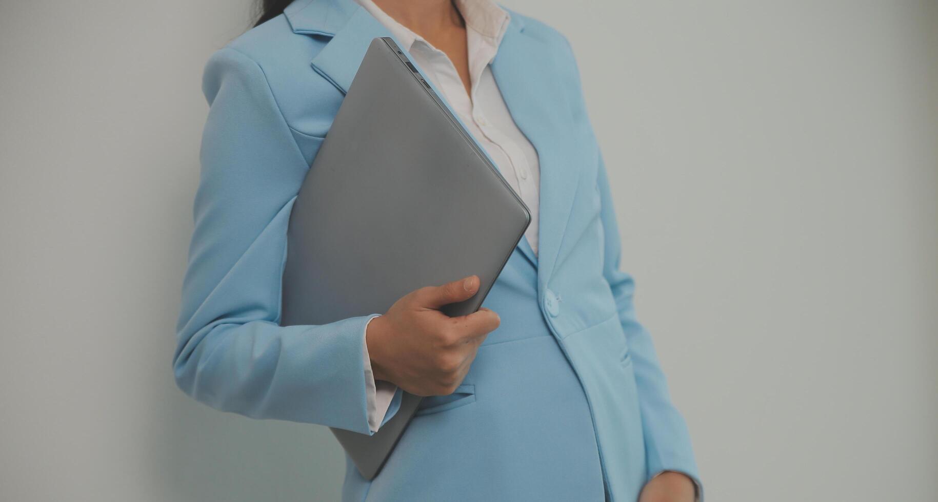 Portrait of a happy asian businesswoman working on laptop computer isolated over white background photo
