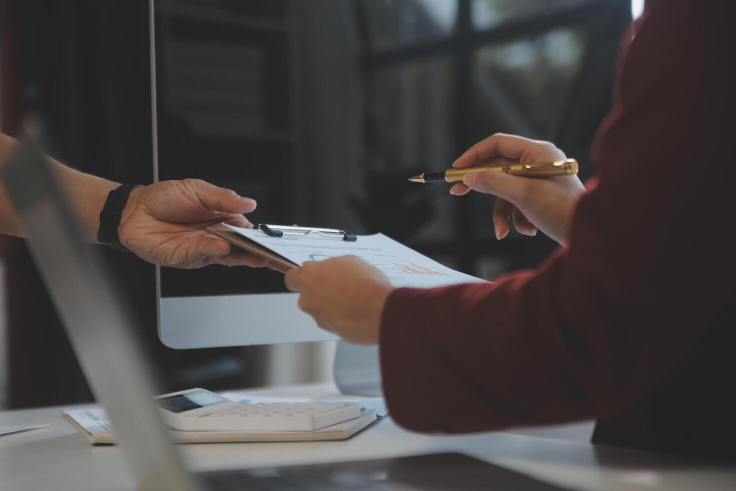 Cropped image of professional businesswoman working at her office via laptop, young female manager using portable computer device while sitting at modern loft, flare light, work process concept photo