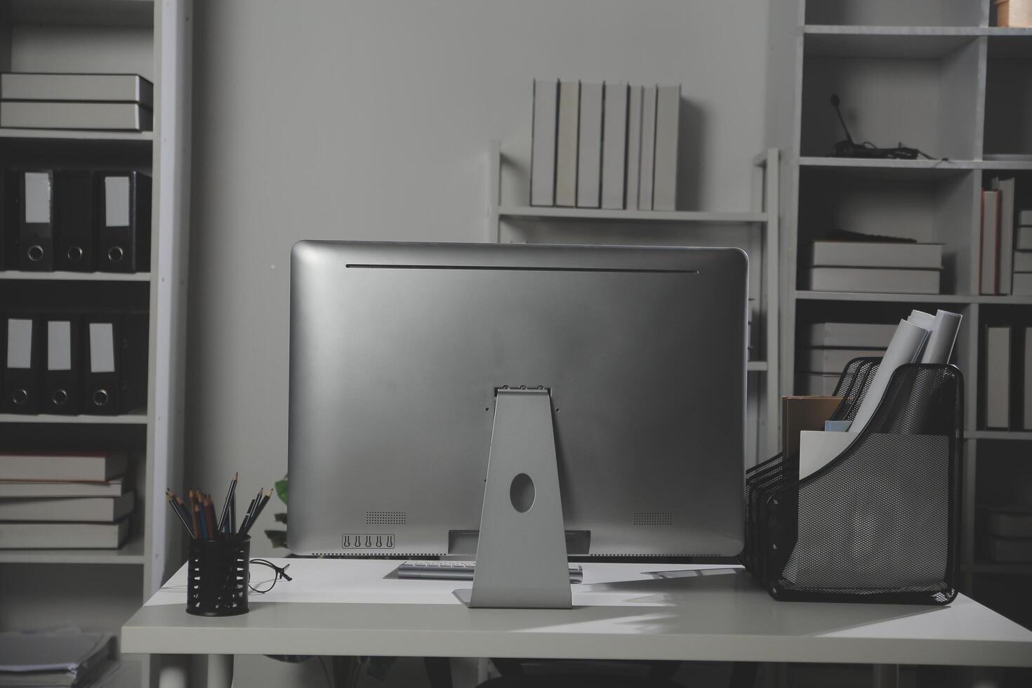 Laptop computer with opened lid on table in meeting room of office workspace. photo