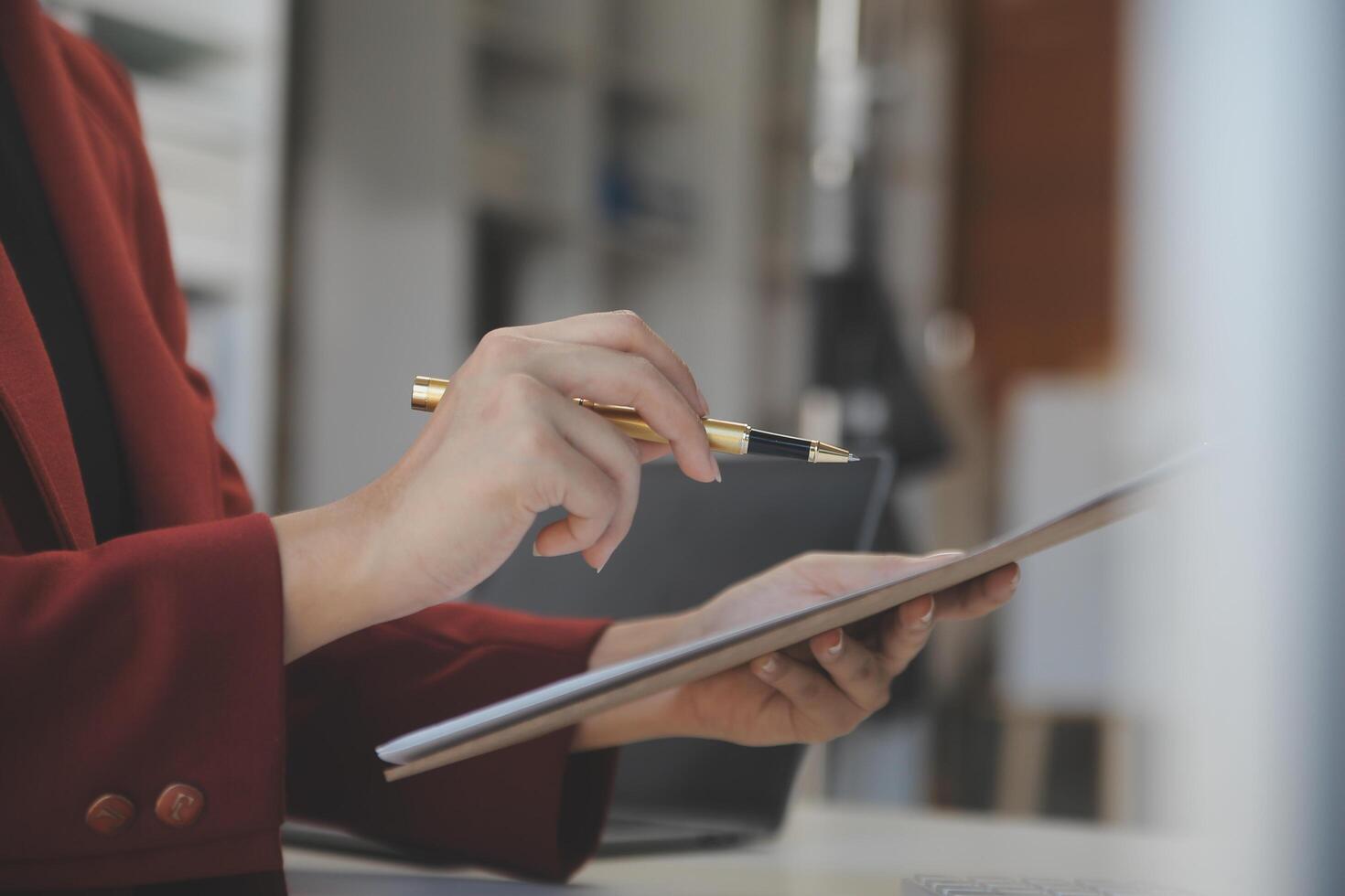 Cropped image of professional businesswoman working at her office via laptop, young female manager using portable computer device while sitting at modern loft, flare light, work process concept photo