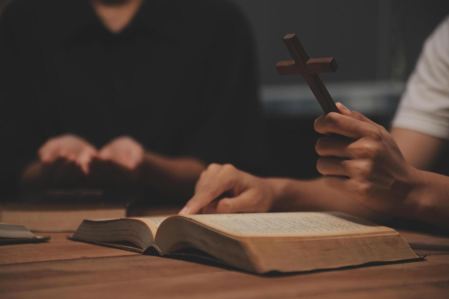 Christian group are praying to god with the bible and sharing the gospel. Concept of faith for god. photo