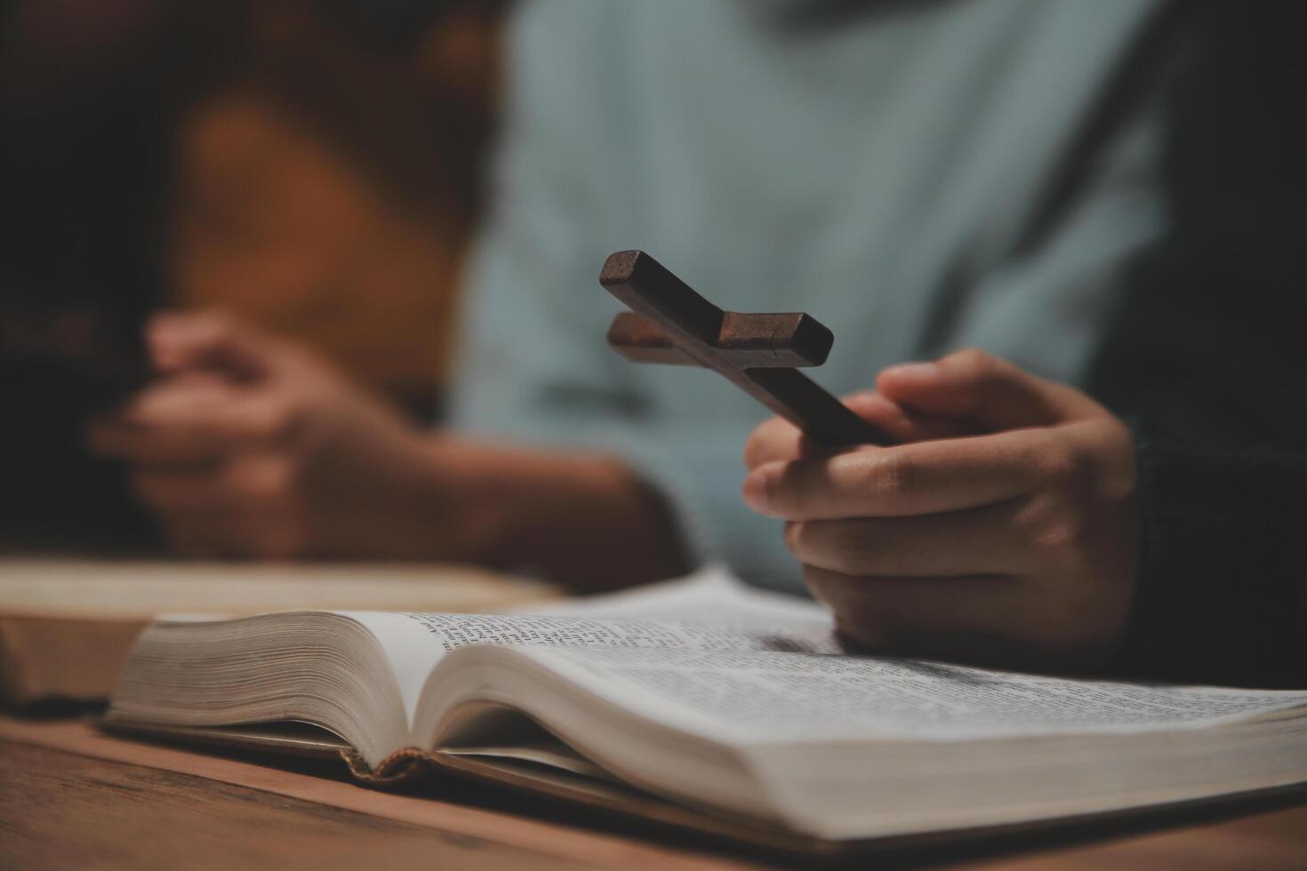 Christian group are praying to god with the bible and sharing the gospel. Concept of faith for god. photo