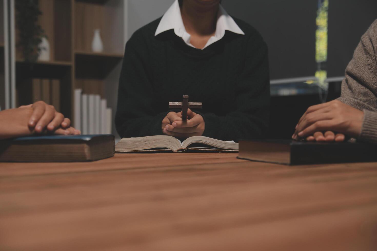 Christian group are praying to god with the bible and sharing the gospel. Concept of faith for god. photo