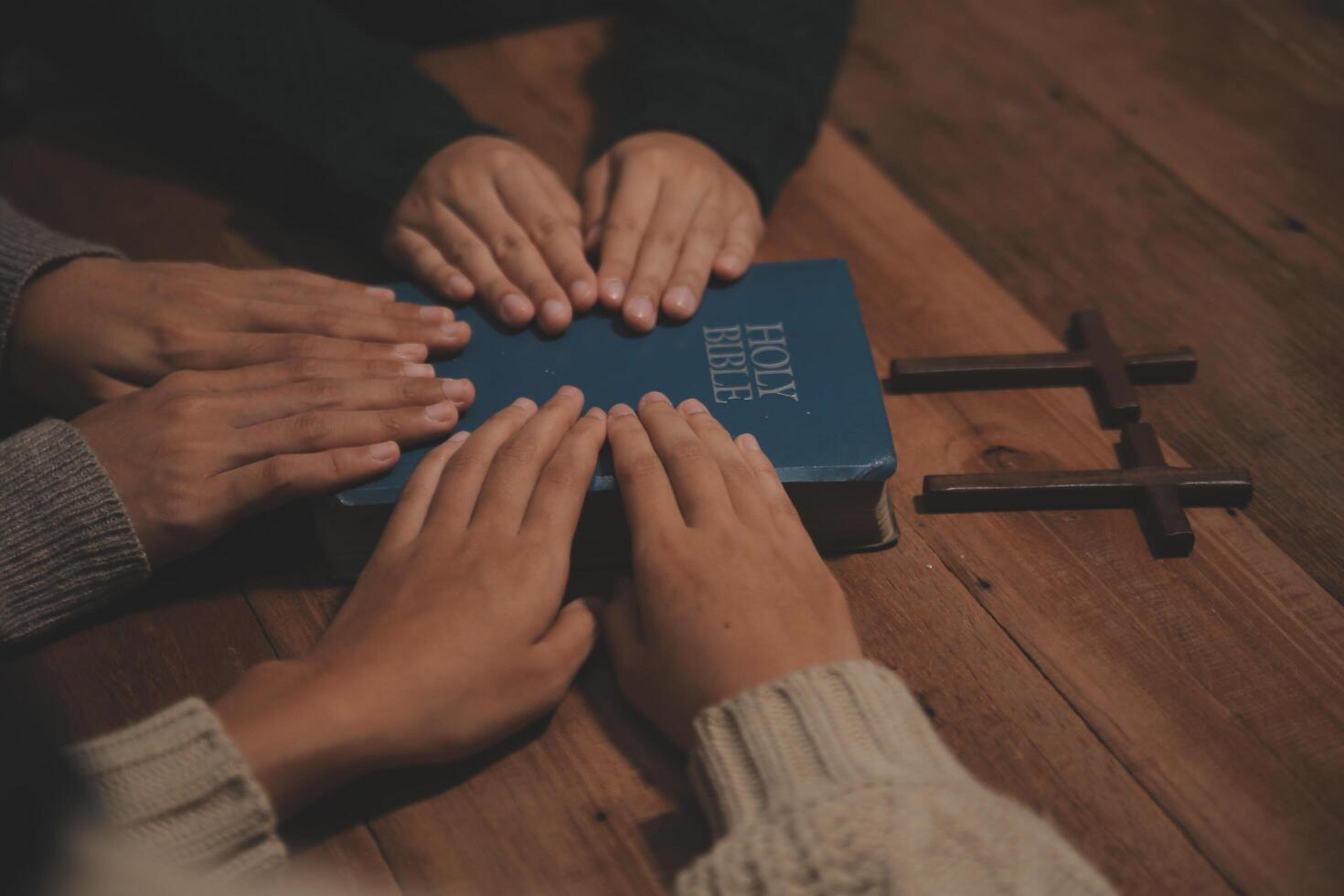 Christian group are praying to god with the bible and sharing the gospel. Concept of faith for god. photo