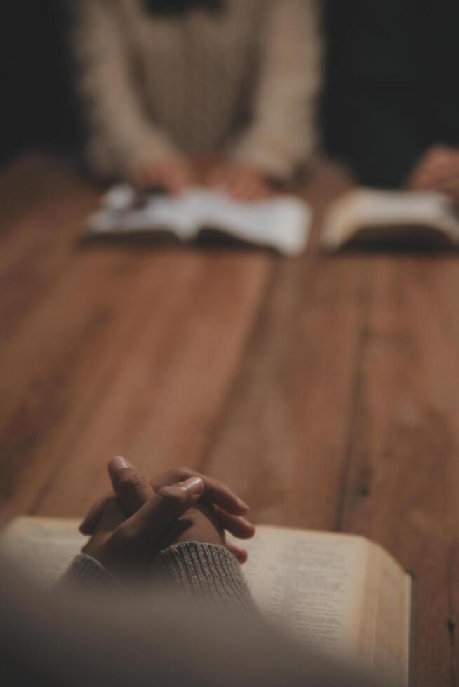 Christian group are praying to god with the bible and sharing the gospel. Concept of faith for god. photo